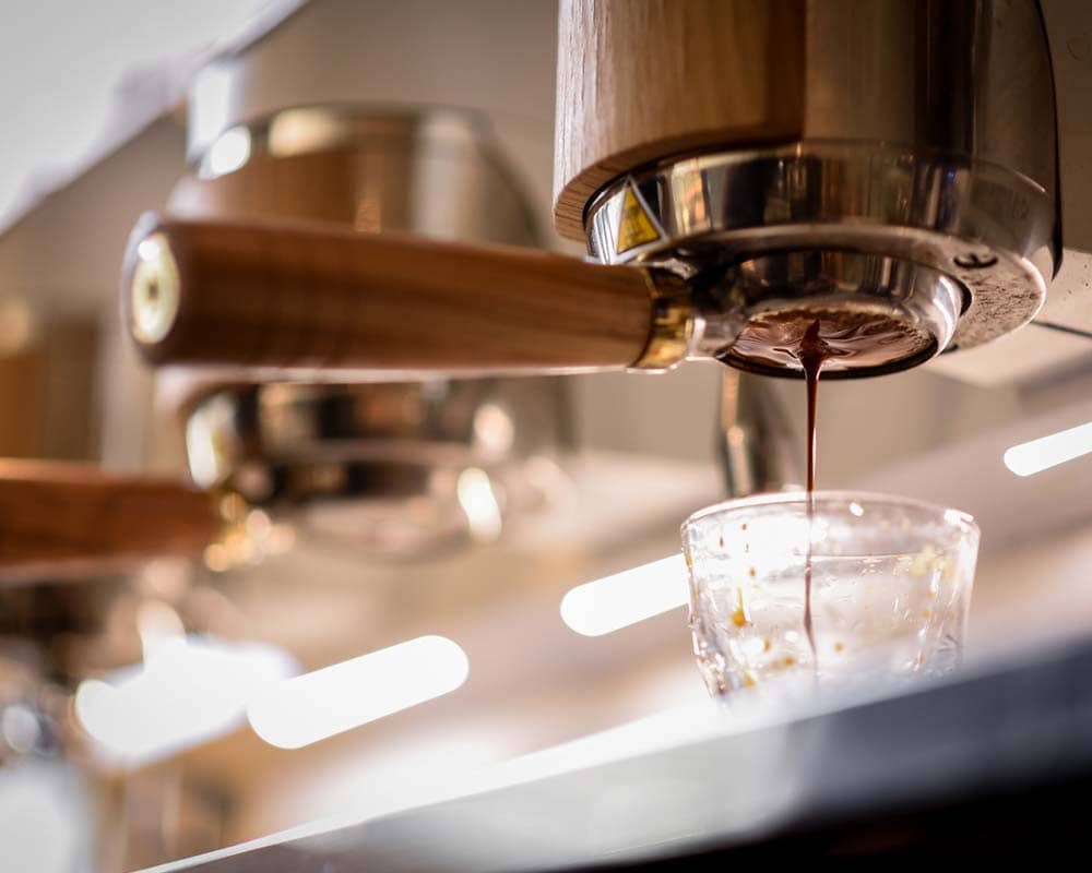 Professional classy espresso machine dripping coffee